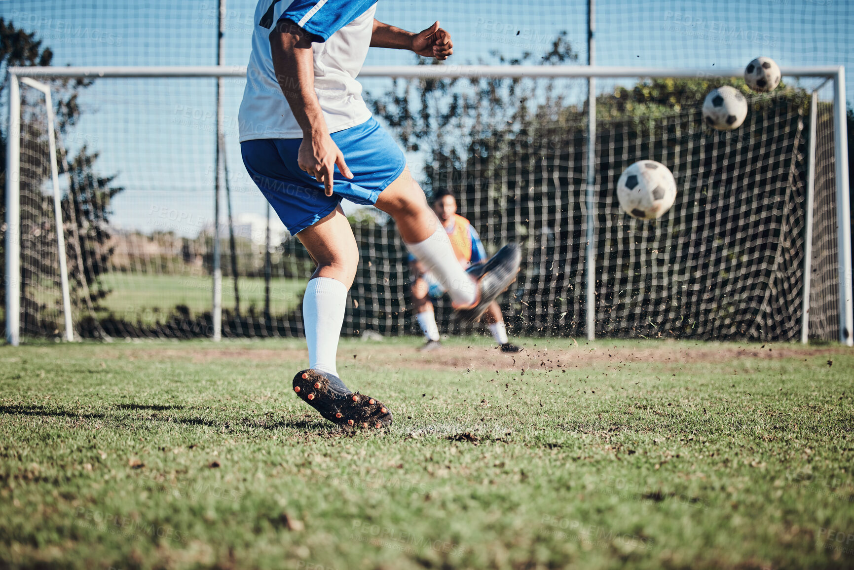 Buy stock photo Sports, training and football player score a goal for challenge at a game or match at tournament. Fitness, exercise and back of soccer athlete kicking a ball at practice on outdoor field at stadium.