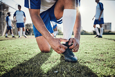Buy stock photo Hands, man and tie shoes on soccer field, prepare for training or fitness games. Closeup, football player or athlete getting ready with sneakers lace in sports, competition and contest on grass pitch