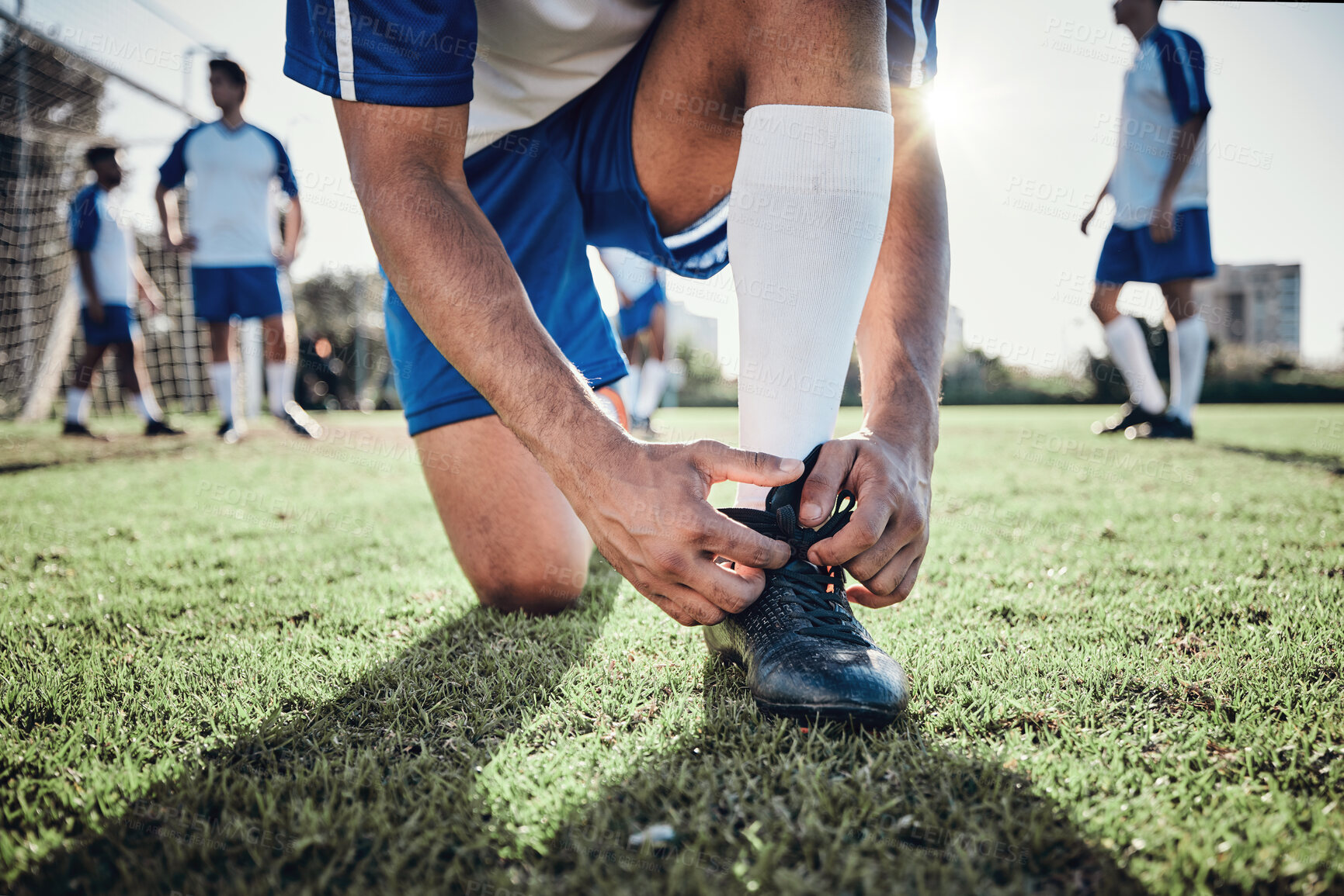 Buy stock photo Hands, man and tie shoes on soccer field, prepare for training or fitness games. Closeup, football player or athlete getting ready with sneakers lace in sports, competition and contest on grass pitch