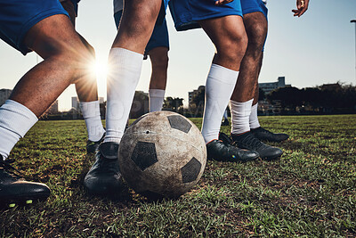 Closeup, ball and soccer with men, game and fitness with sports, competition and workout goals. Zoom, football and athletes with energy, exercise and training for a match, action and tackle challenge