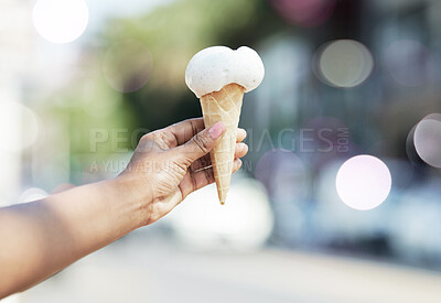 Buy stock photo Hands, person and ice cream cone in city for dessert, cool snack and sweet food to enjoy outdoor. Closeup, scoop and frozen vanilla gelato in summer, travel and sunshine of urban town, street or trip