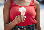 Hands, woman and vanilla ice cream for dessert, cool snack and sweet food outdoor in city street, vacation or travel. Closeup, female person and eating frozen cone, melting gelato and dripping summer