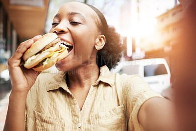Buy stock photo Burger, eating and black woman in selfie, city and restaurant for outdoor promotion, social media and live streaming review. Fast food, hungry customer, person or influencer with lunch or photography