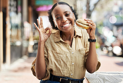 Buy stock photo Burger, okay sign and portrait of woman in city, outdoor restaurant and happy customer experience or services. Fast food, like and excited african person with lunch review, excellence and yes emoji