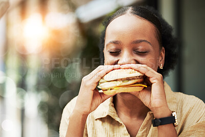 Buy stock photo Happy, fast food and black woman eating a sandwich in an outdoor restaurant as a lunch meal craving deal. Breakfast, burger and young female person or customer enjoying a tasty unhealthy snack