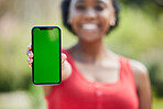 Woman, hands and phone mockup green screen for advertising, mobile app or communication in nature. Female person show smartphone display or chromakey for advertisement or marketing in the outdoors