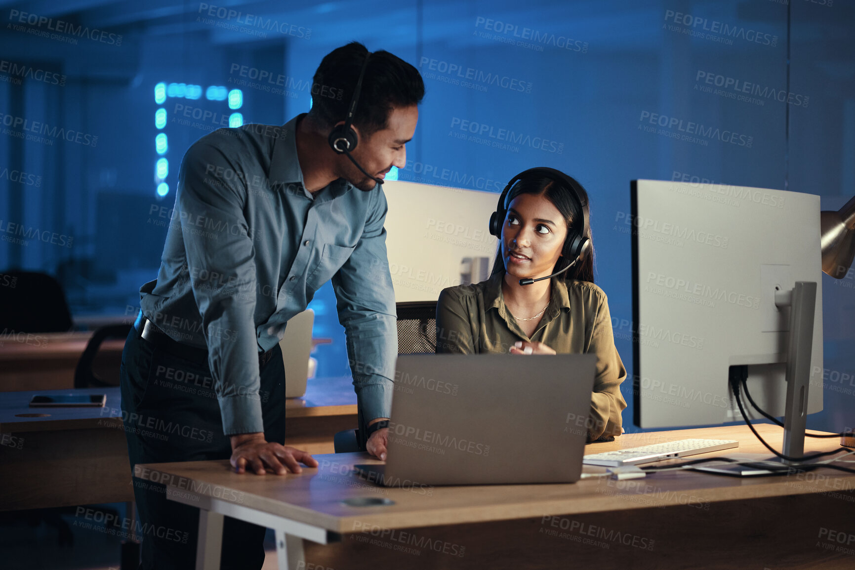 Buy stock photo Business people, call center and laptop at night in customer service or tech support at the office. Businessman and woman working late together for virtual assistant, consultant or agent at workplace