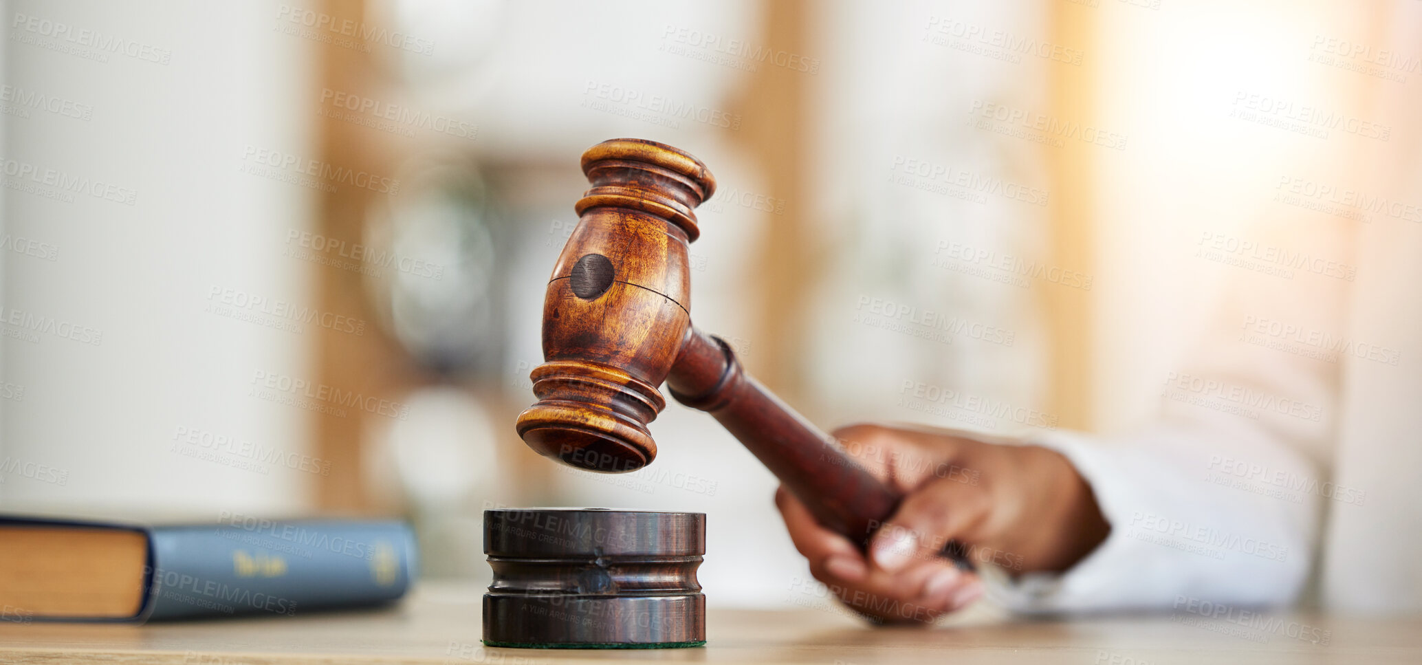 Buy stock photo Closeup, lawyer and gavel of judge in office of trial, attention and meeting for justice in courtroom, law firm or table. Hammer, legal tool and hands of person for decision, constitution or attorney