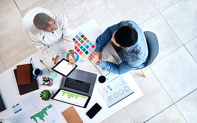 Buy stock photo Top view, business people and laptop for web design at desk with teamwork, blank tablet and marketing. Man, woman and planning for ux with chart, data analytics and collaboration at tech startup