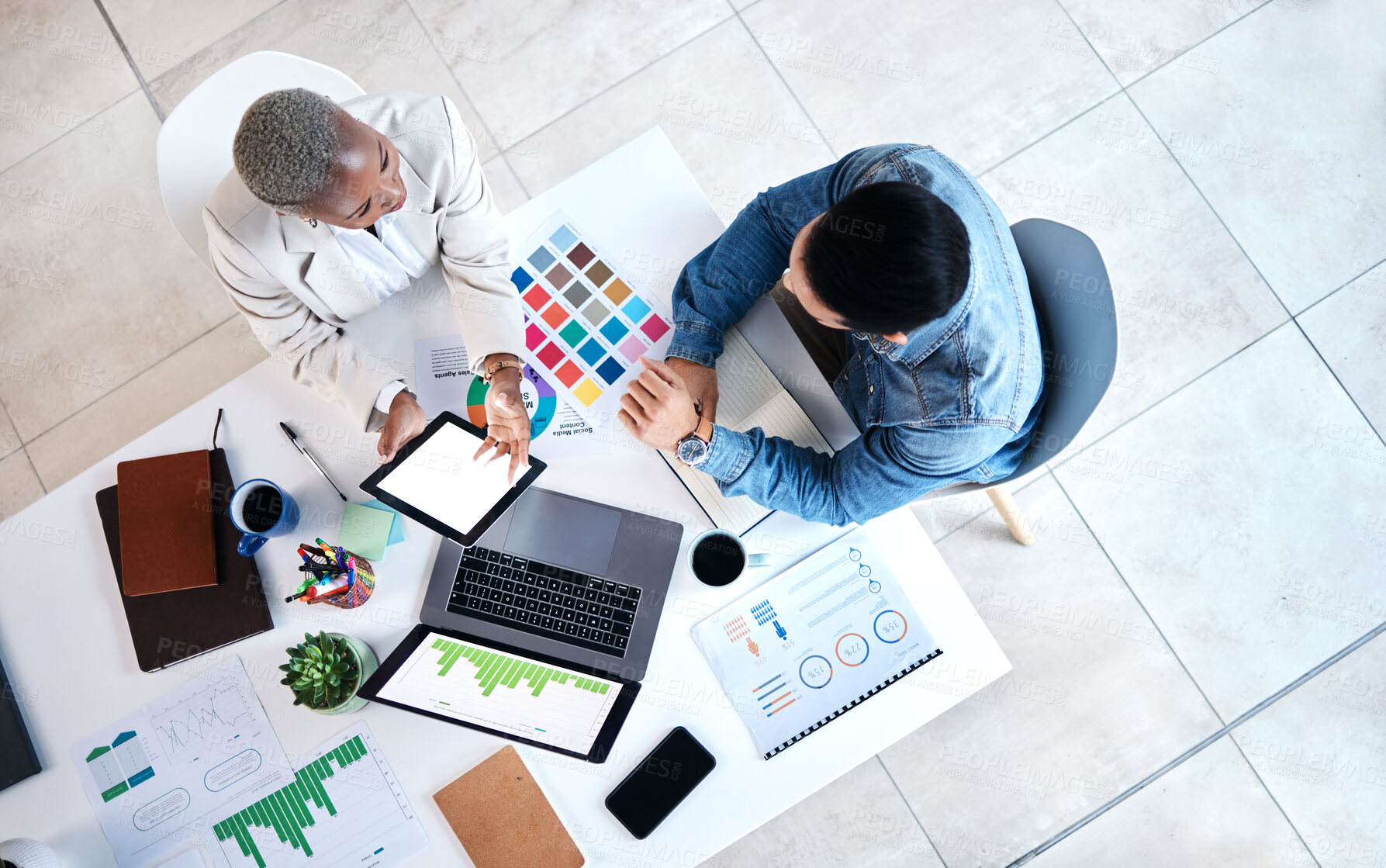 Buy stock photo Top view, business people and laptop for web design at desk with teamwork, blank tablet and marketing. Man, woman and planning for ux with chart, data analytics and collaboration at tech startup