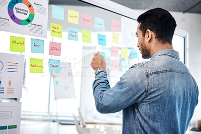 Buy stock photo Creative man, sticky note and glass board for schedule tasks, planning or brainstorming at the office. Male person or employee checking plan, agenda or marketing strategy for startup at the workplace