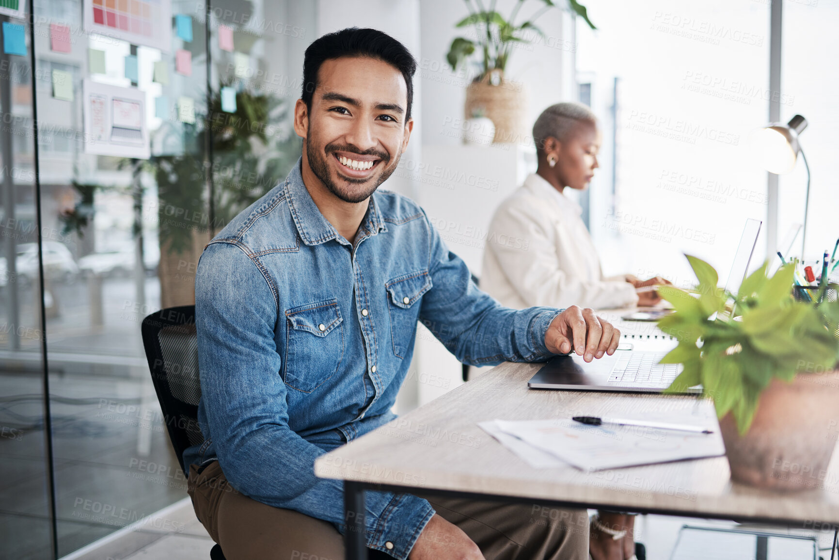 Buy stock photo Portrait of happy man at desk in coworking space with laptop, notes and work at design agency. Business, smile and computer, employee in office with confidence in creative career at tech startup job.