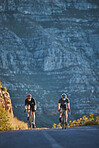 Mountain, fitness and male athletes cycling on bicycles training for a race or marathon in nature. Sports, workout and men cyclists riding a bike for cardio exercise on an outdoor off road trail.