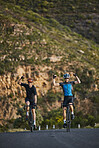 Celebration, sports and men athletes cycling on bicycles training for a race or marathon in nature. Fitness, winning and male cyclists riding a bike for cardio exercise on an outdoor off road trail.