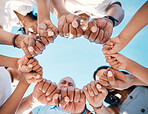 Circle, hands and fist bump by people in support of collaboration, motivation and goal from below. Fingers, team building and group with emoji for power, trust and unity, teamwork and partnership