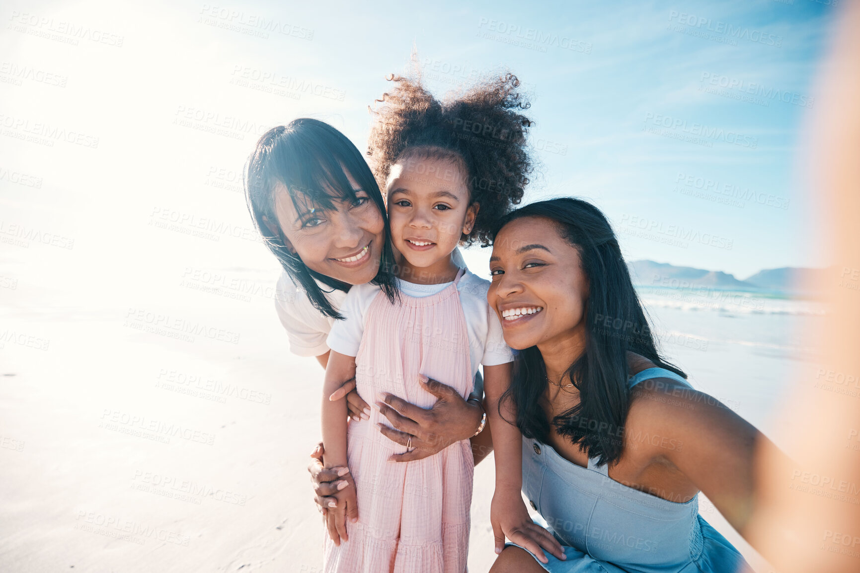 Buy stock photo Selfie of mother, daughter and grandmother on the beach together during summer for vacation or bonding. Portrait, family or children and a little girl in nature with her parent and senior grandparent