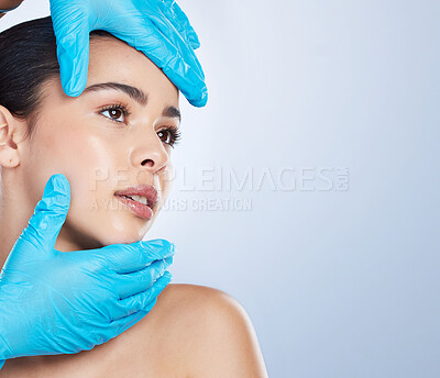 Buy stock photo Woman, plastic surgery and gloves on face in studio, check and cosmetics with mockup space by background. Young girl, model and surgeon hands with thinking, inspection and measurement for aesthetic