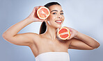 Skincare, portrait and woman with grapefruit in a studio for a natural, organic or health face routine. Beauty, self care and female model with citrus fruit for a facial treatment by gray background.