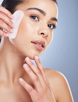 Buy stock photo Gua sha, crystal and portrait of asian woman with skincare tool in studio for anti aging or fine lines on grey background. Rose quartz, stone and lady face wellness model with facial beauty massage 