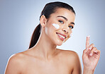 Portrait, skincare and happy woman with face cream in studio for anti aging, wellness or hydration on grey background. Facial, smile and lady model with sunscreen, lotion or beauty mask application