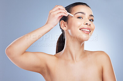 Buy stock photo Portrait of a woman plucking her eyebrows in a studio for grooming or hair removal face routine. Skincare, beauty and female model doing a facial epilation treatment with tweezers by gray background.