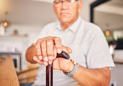 Buy stock photo Hands, serious and portrait of a man with a cane for medical help, senior support and health. Sad, house and an elderly person with a disability in the living room with a walking stick closeup