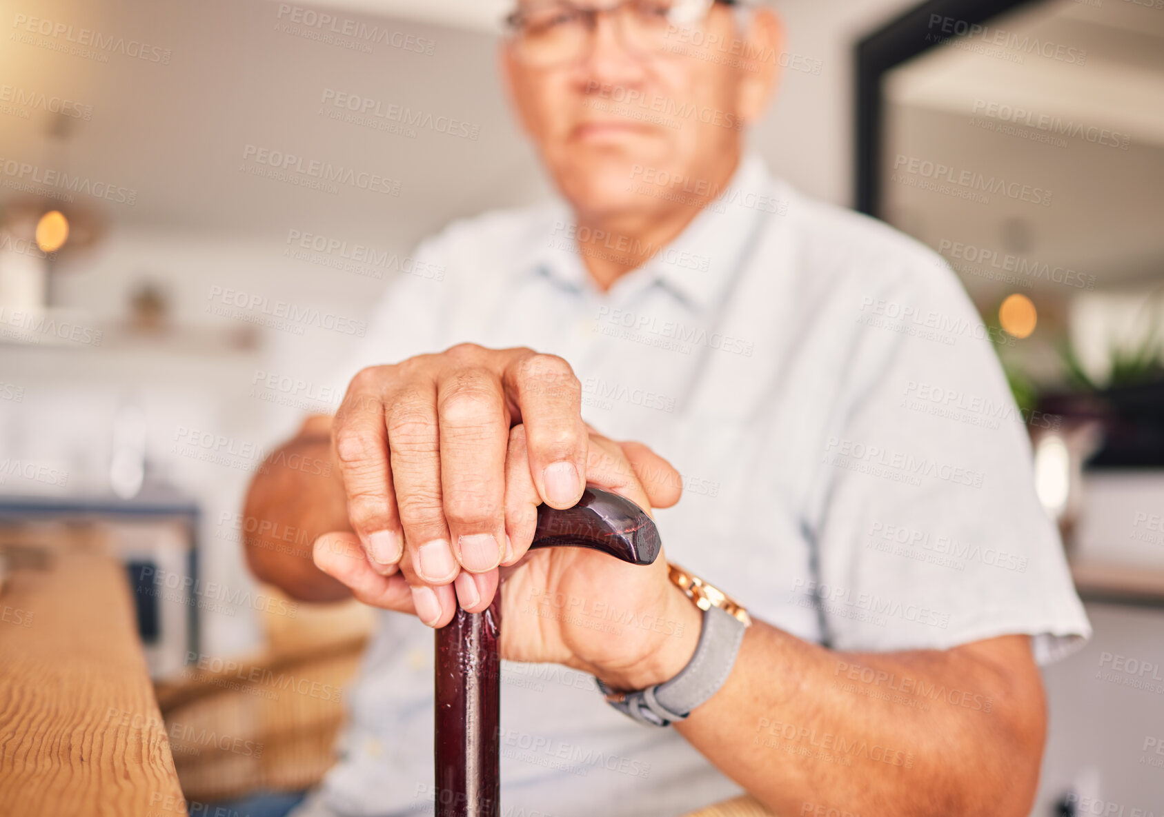 Buy stock photo Hands, serious and portrait of a man with a cane for medical help, senior support and health. Sad, house and an elderly person with a disability in the living room with a walking stick closeup