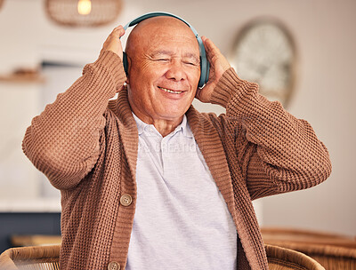 Buy stock photo Happy, senior and a man with headphones for music, podcast or audio while in a home. Smile, relax and an elderly person with radio, streaming track or listening to a playlist on electronic gear