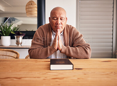 Buy stock photo Senior man, bible and praying in home with faith, religion and mindfulness for peace, gratitude and Jesus. Elderly person, eyes closed and worship christian God with spiritual mindset, focus or trust