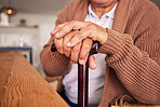 Closeup, hands and cane of person with disability, arthritis and aid of osteoporosis, parkinson or stroke. Retirement, senior patient and holding walking stick of support, help or healthcare mobility