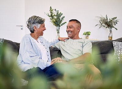 Buy stock photo Love, happy and laughing elderly couple relax, speaking and enjoy funny conversation, care or chat in home apartment. Holding hands, comedy and senior woman, man or people laugh at relationship joke