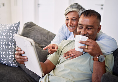 Buy stock photo Home, tablet and happy senior couple on sofa, relax and check email, news article and point at online shopping choice. Website info, decision or elderly man, old woman or people smile in living room