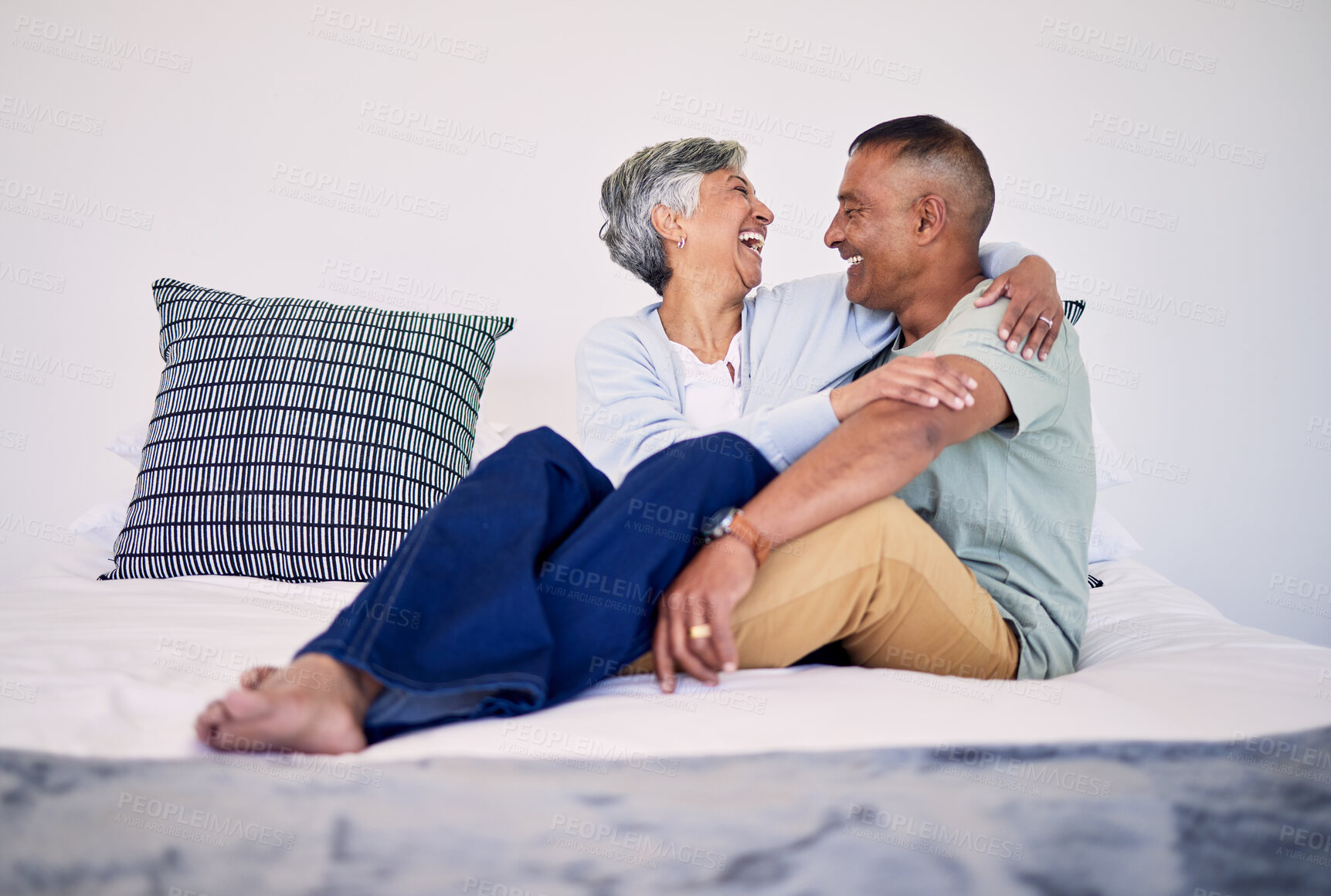 Buy stock photo Hug, bedroom and laughing senior couple bonding, talking and enjoy quality time, funny conversation or trust. Morning discussion, marriage humour and relax elderly people laugh at comedy joke on bed