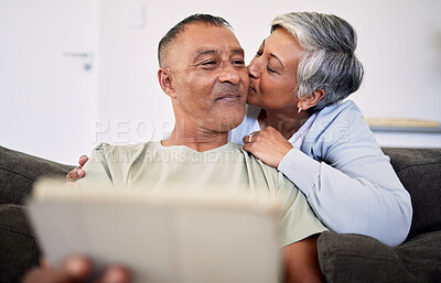 Buy stock photo Marriage, kiss and senior man or woman on sofa for retirement or quality time in home. Couple, hug and elderly man or woman with tech in living room for bonding together with internet on couch.