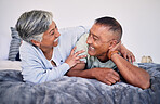 Love, bedroom and laughing senior couple bonding, happy and enjoy quality time together, funny conversation or comedy. Smile, marriage humour and relax elderly people laugh at retirement joke on bed