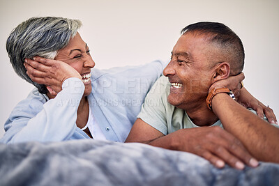 Buy stock photo Love, bedroom face and elderly couple laugh, bond and enjoy quality time together, funny conversation and relax. Home rest, marriage care or senior woman, old man or retirement people laughing in bed