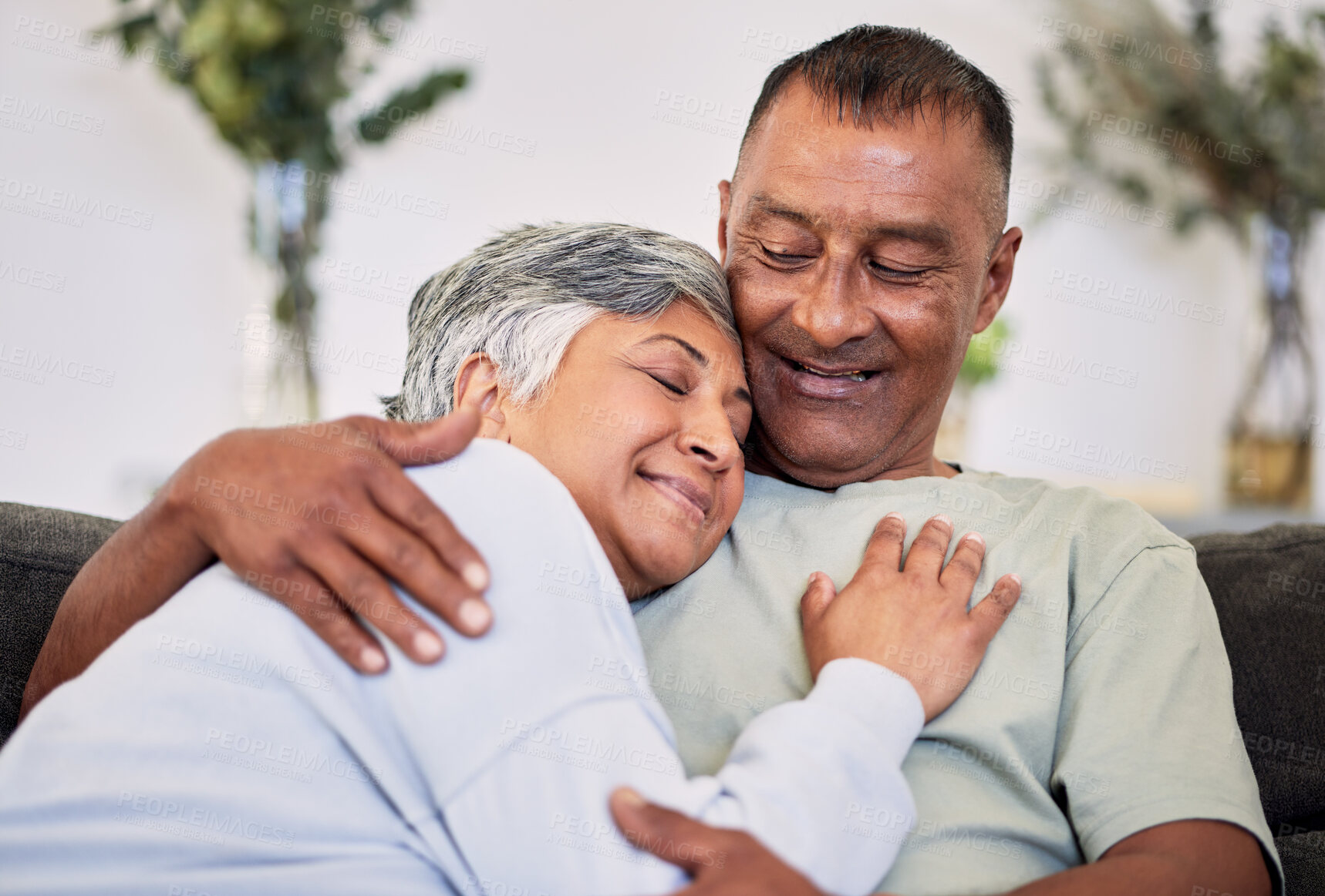 Buy stock photo Retirement, love and care with mature couple on sofa to relax in family home for bond. Marriage, smile and senior man or woman in living room for rest or calm with happiness for relationship together