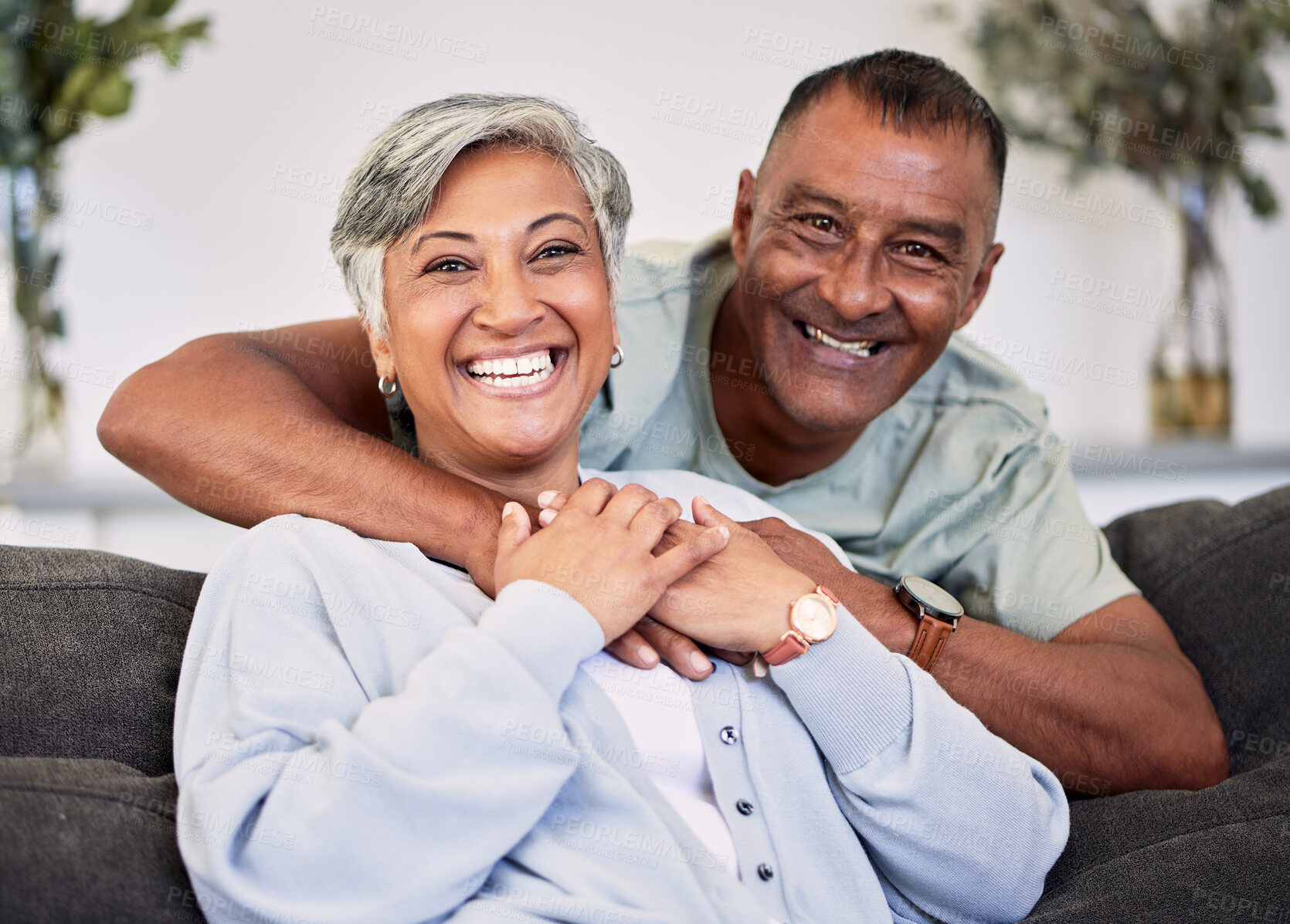 Buy stock photo Portrait, happiness and senior couple on sofa with hug for quality time in living room to relax. Smile, marriage and elder man or woman with embrace on couch with love or care for bonding together.