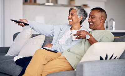 Buy stock photo Senior couple, watching tv and relax on couch in home living room, laugh and together for funny comedy show. Elderly man, old woman and remote control for video, comic movie and lounge sofa in house