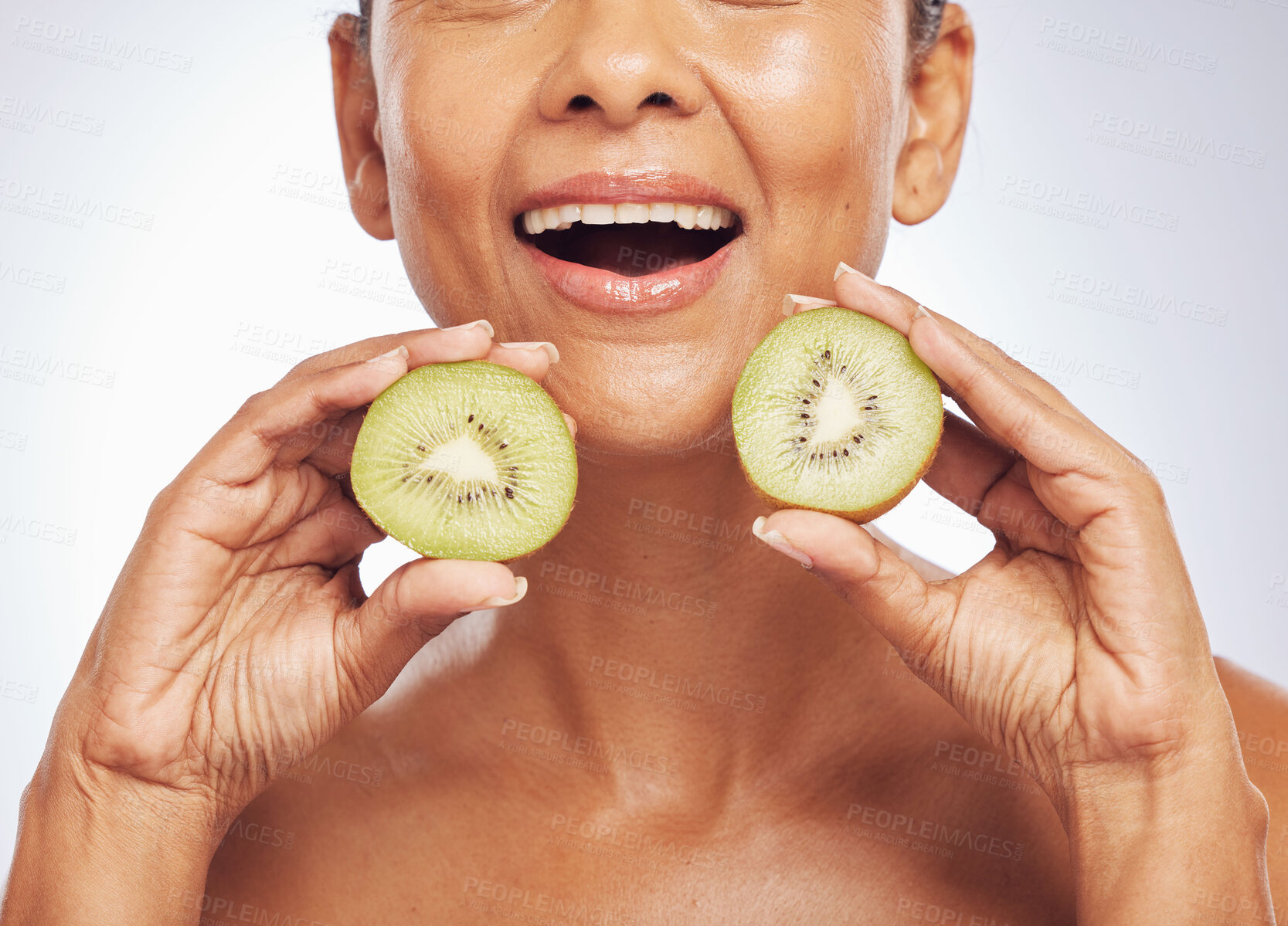 Buy stock photo Excited, face and senior woman with kiwi in studio isolated on a white background. Food, fruit and natural model with nutrition for skincare, diet and vitamin c for anti aging, cosmetics or health