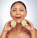 Face, excited and mature woman with kiwi in studio isolated on a white background. Portrait, fruit and natural model with food for nutrition, skincare and diet for vitamin c, anti aging and health.