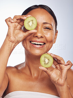 Buy stock photo Face, skincare and senior woman with kiwi in studio isolated on a white background. Food, natural fruit and portrait of happy model with nutrition for wellness, healthy diet and anti aging for beauty