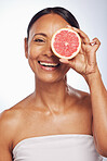 Skincare, face and mature woman with grapefruit in studio isolated on a white background. Portrait, natural fruit and happy model with food for nutrition, wellness and healthy diet for anti aging.