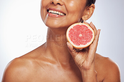 Buy stock photo Skincare, beauty and happy woman with grapefruit in studio isolated on a white background. Food, natural fruit and hand of model with nutrition for wellness, healthy diet and vitamin c for anti aging