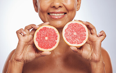 Buy stock photo Skincare, hands and happy woman with grapefruit in studio isolated on a white background. Food, natural fruit and mature model with nutrition for wellness, healthy diet and vitamin c for anti aging.