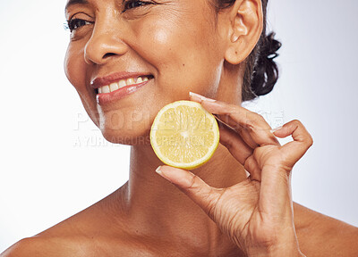 Buy stock photo Thinking, orange and senior woman with skincare, cosmetics and vitamin c against a white studio background. Mature female person, happy lady or model with citrus fruit, natural beauty and nutrition