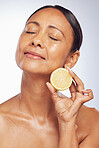 Cosmetics, orange and senior woman with skincare, dermatology and vitamin c against a white studio background. Mature female person, self care and model with citrus fruit, natural beauty and health