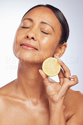 Buy stock photo Cosmetics, orange and senior woman with skincare, dermatology and vitamin c against a white studio background. Mature female person, self care and model with citrus fruit, natural beauty and health