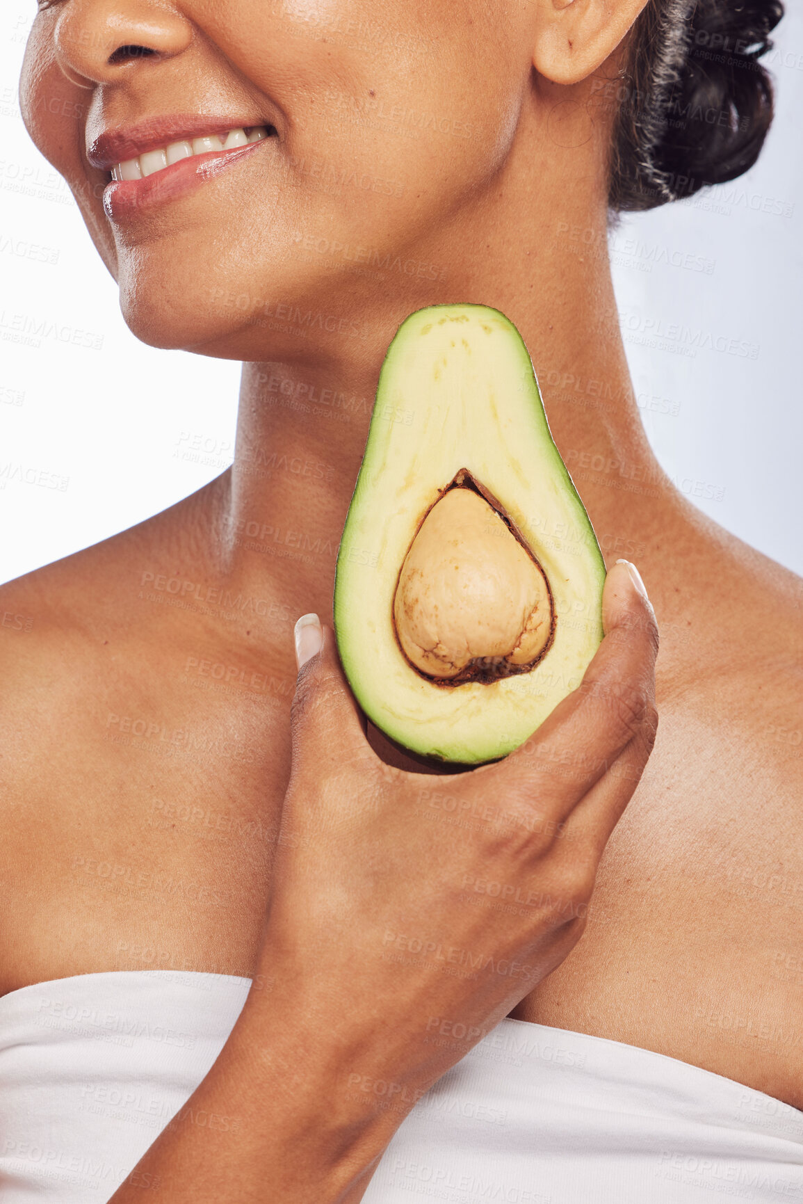 Buy stock photo Avocado, skincare or happy woman with fruit for natural cleaning, detox or healthy skin with beauty. Wellness, hand or closeup of model smiling in dermatology treatment in studio or white background