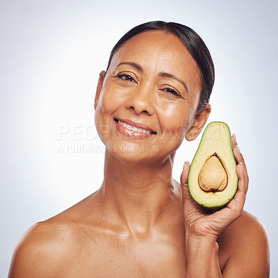 Buy stock photo Face, skincare and senior woman with avocado in studio isolated on a white background. Portrait, natural fruit and happy model with food for organic nutrition, healthy diet and omega 3 for anti aging